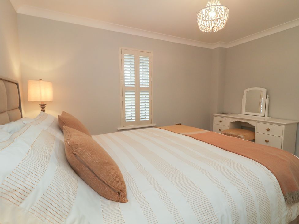 A bedroom with a bed and vanity at 2 Ard an Chuain Dunfanaghy