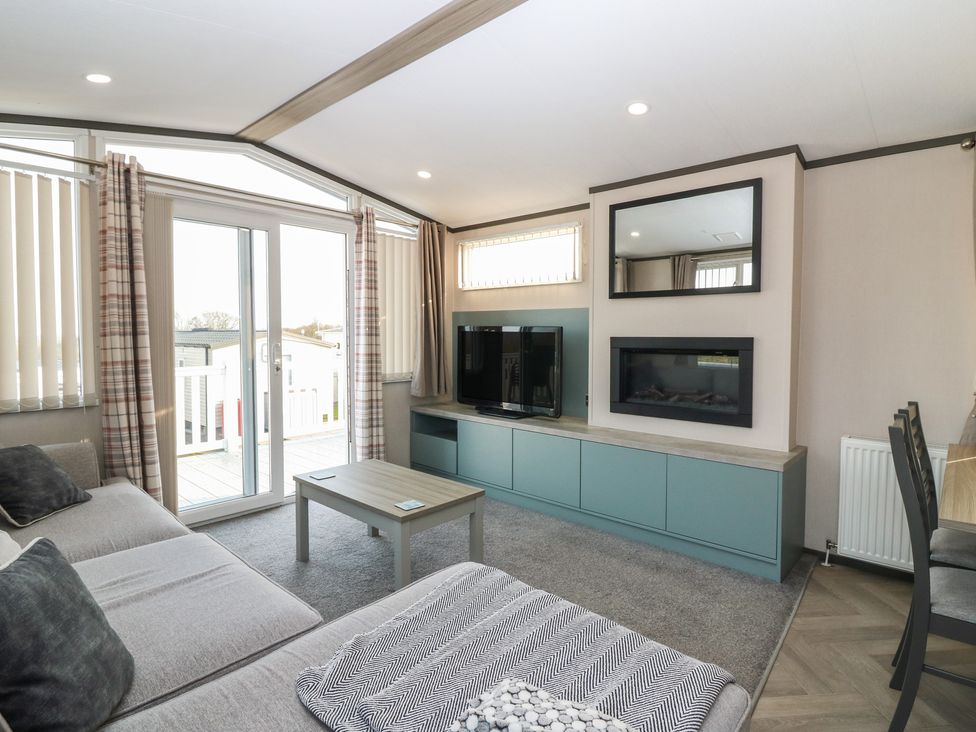 A living room with a sofa and television at Plot 243 - Coldingham Bay Leisure Park Eyemouth