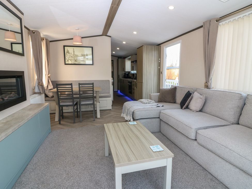 A living room with a sofa and dining table at Plot 243 - Coldingham Bay Leisure Park, Eyemouth