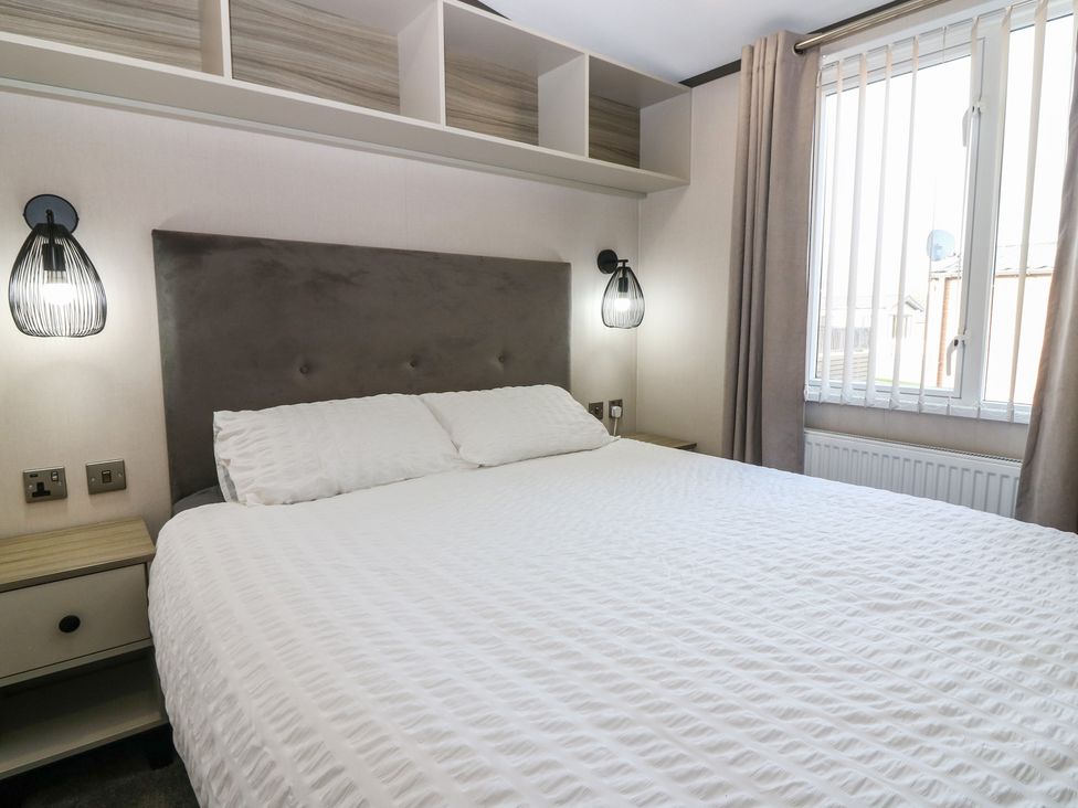 A bedroom with a bed and bedside lights at Plot 243 - Coldingham Bay Leisure Park Eyemouth