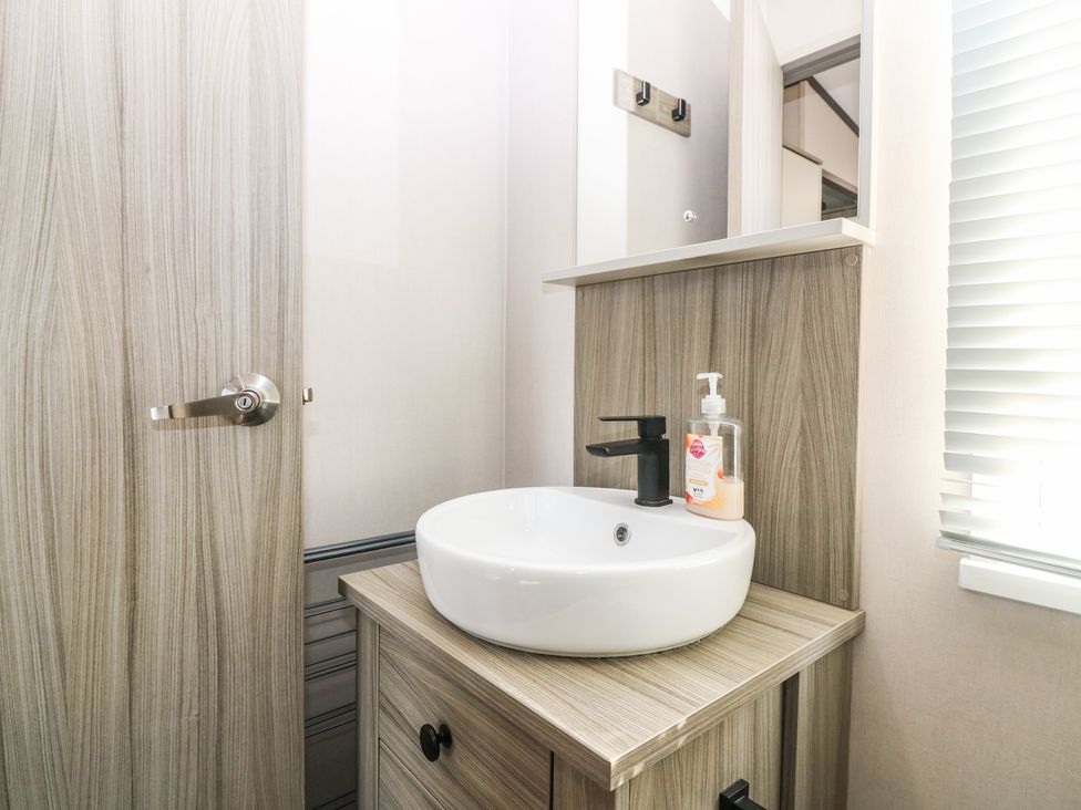 A bathroom with a sink and cabinet at Plot 243 - Coldingham Bay Leisure Park Eyemouth