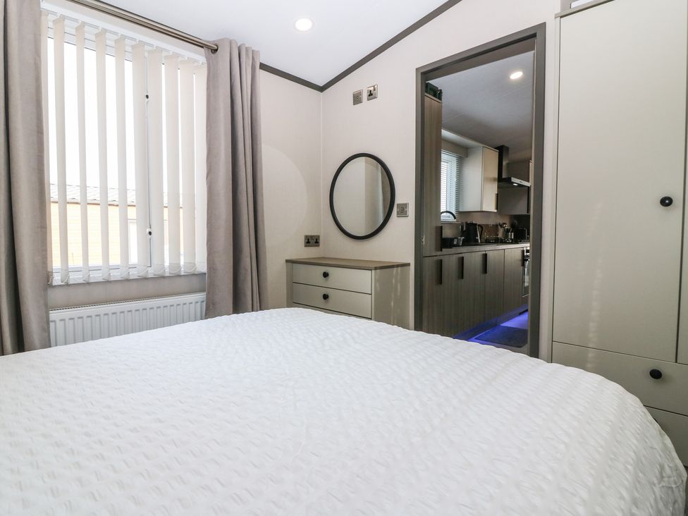 A bedroom with a bed and closet at Plot 243 - Coldingham Bay Leisure Park Eyemouth