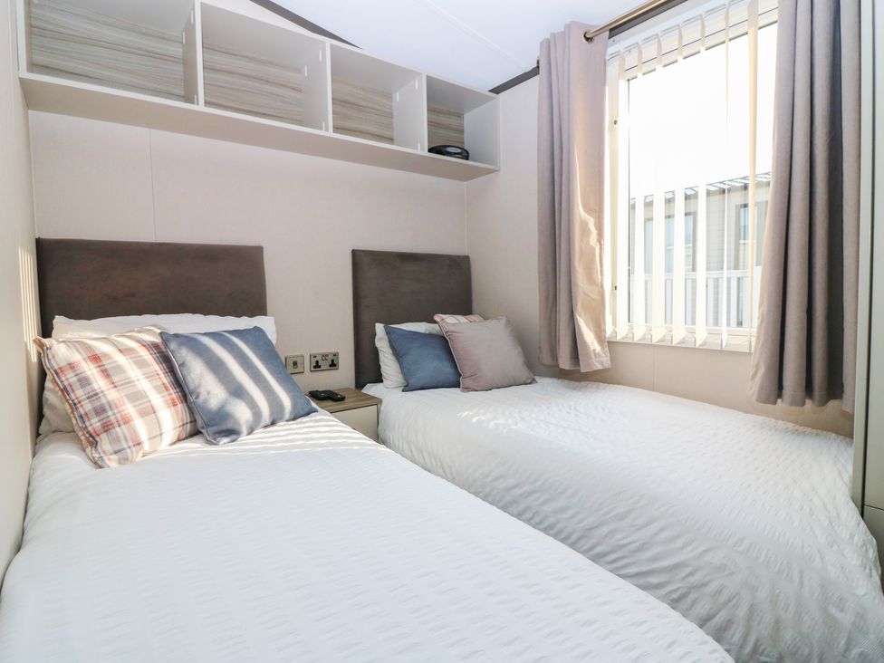 A bedroom with two beds and a window at Plot 243 - Coldingham Bay Leisure Park Eyemouth