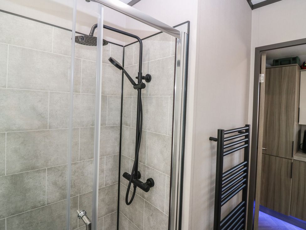 A shower with a glass enclosure and towel radiator at Plot 243 - Coldingham Bay Leisure Park Eyemouth