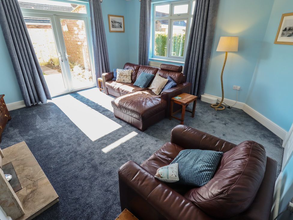A living room with sofas and a coffee table at Sorrento in Mablethorpe
