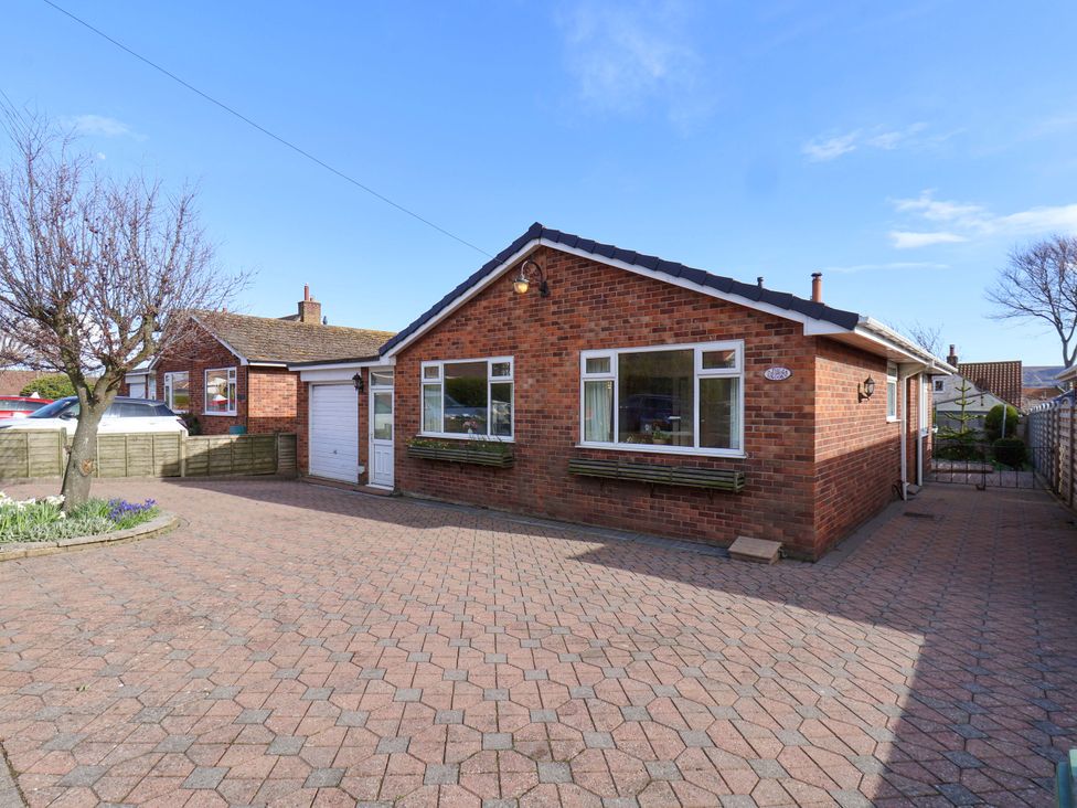 A house with a driveway and garage at The Nook in Robin Hood’s Bay