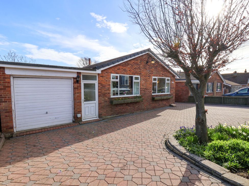 A house with a driveway and garage at The Nook in Robin Hood’s Bay