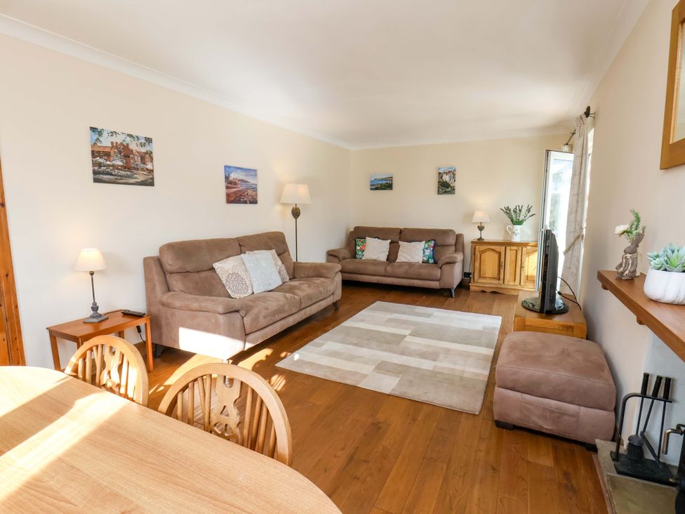 A living room with sofas, a coffee table and a television at The Nook in Robin Hood’s Bay