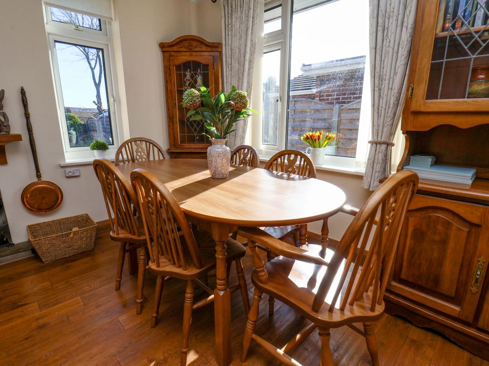 A dining room with a wooden table and chairs at The Nook in Robin Hood’s Bay
