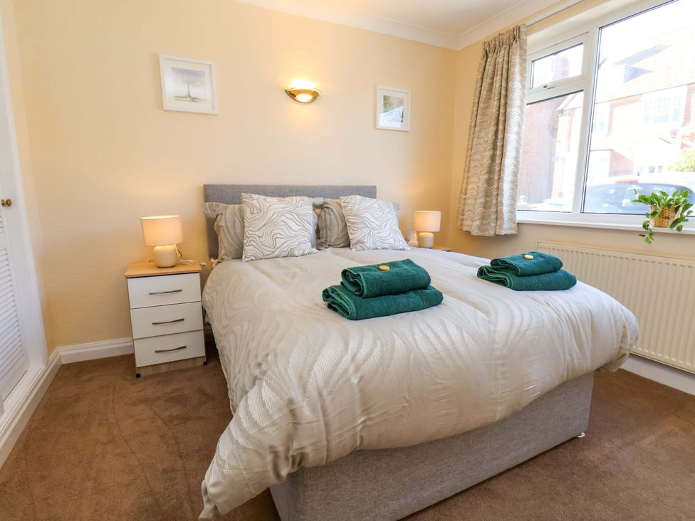 A bedroom with a bed and bedside table at The Nook in Robin Hood’s Bay