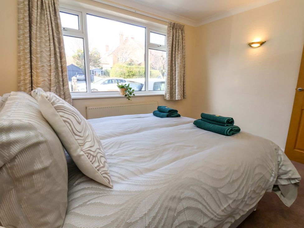 A bedroom with a bed and towels on it at The Nook in Robin Hood’s Bay