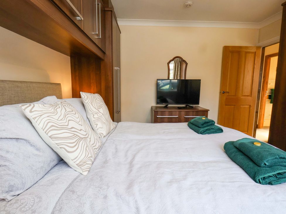 A bedroom with a bed and television at The Nook in Robin Hood’s Bay