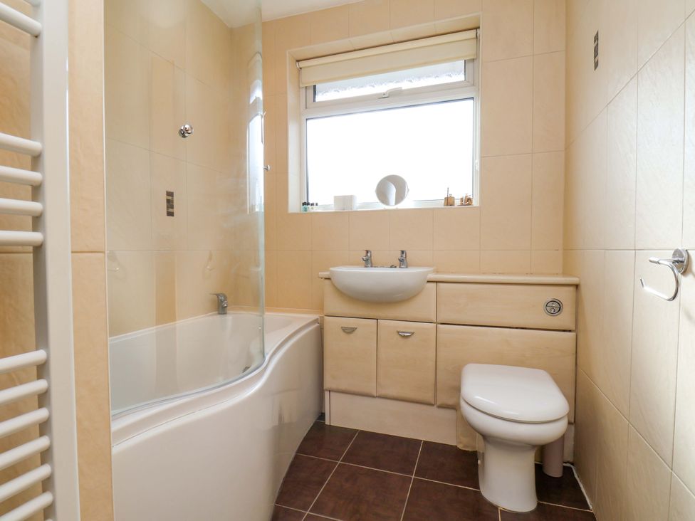 A bathroom with a bathtub and sink at The Nook in Robin Hood’s Bay