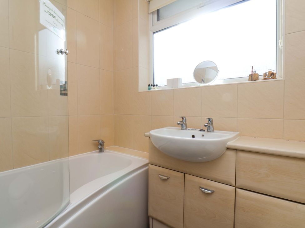 A bathroom with a bathtub and sink at The Nook in Robin Hood’s Bay