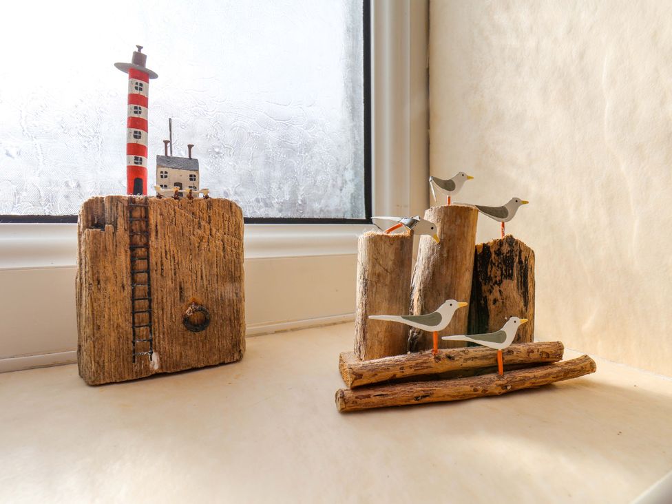 A decorative display with a lighthouse and wooden birds at The Nook in Robin Hood’s Bay