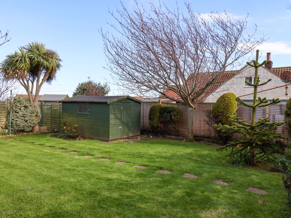 A garden with a shed and trees at The Nook in Robin Hood’s Bay