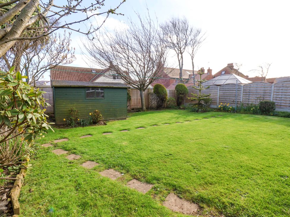 A garden with a shed and pathway at The Nook in Robin Hood’s Bay