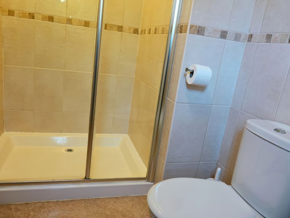 A bathroom with a shower and a toilet at Bracken Lodge Finlakes Holiday Park near Chudleigh