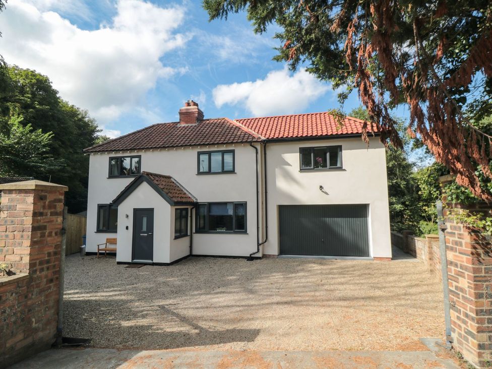 A house with a garage and driveway at Riverside House in Scarborough