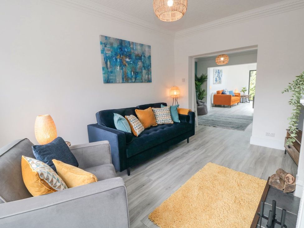 A living room with a sofa and armchair at Riverside House in Scarborough