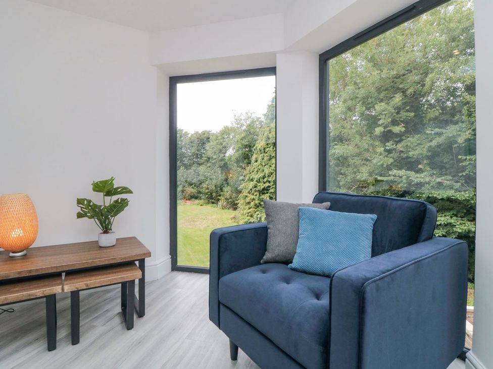 A living room with an armchair and a table at Riverside House in Scarborough