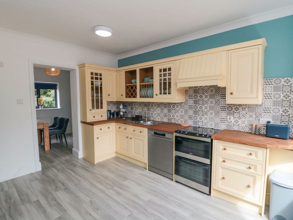 A kitchen with cabinets and appliances at Riverside House in Scarborough