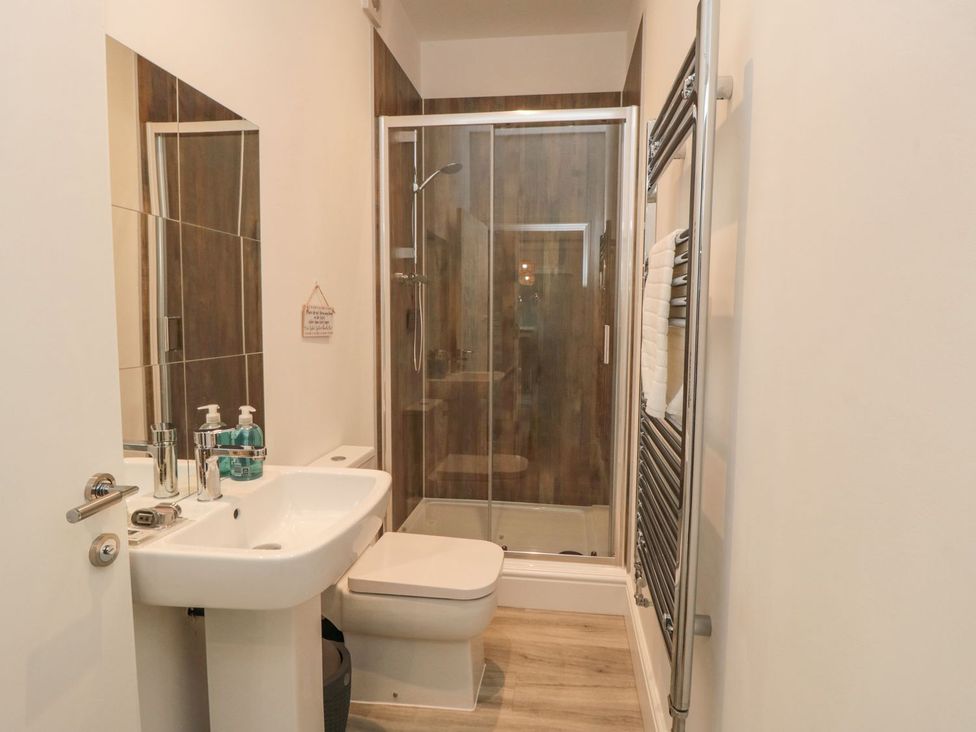 A bathroom with a sink, toilet, and shower at Riverside House in Scarborough