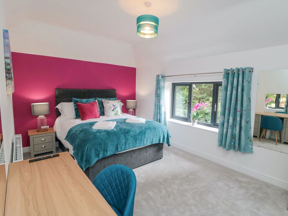 A bedroom with a bed and desk at Riverside House in Scarborough