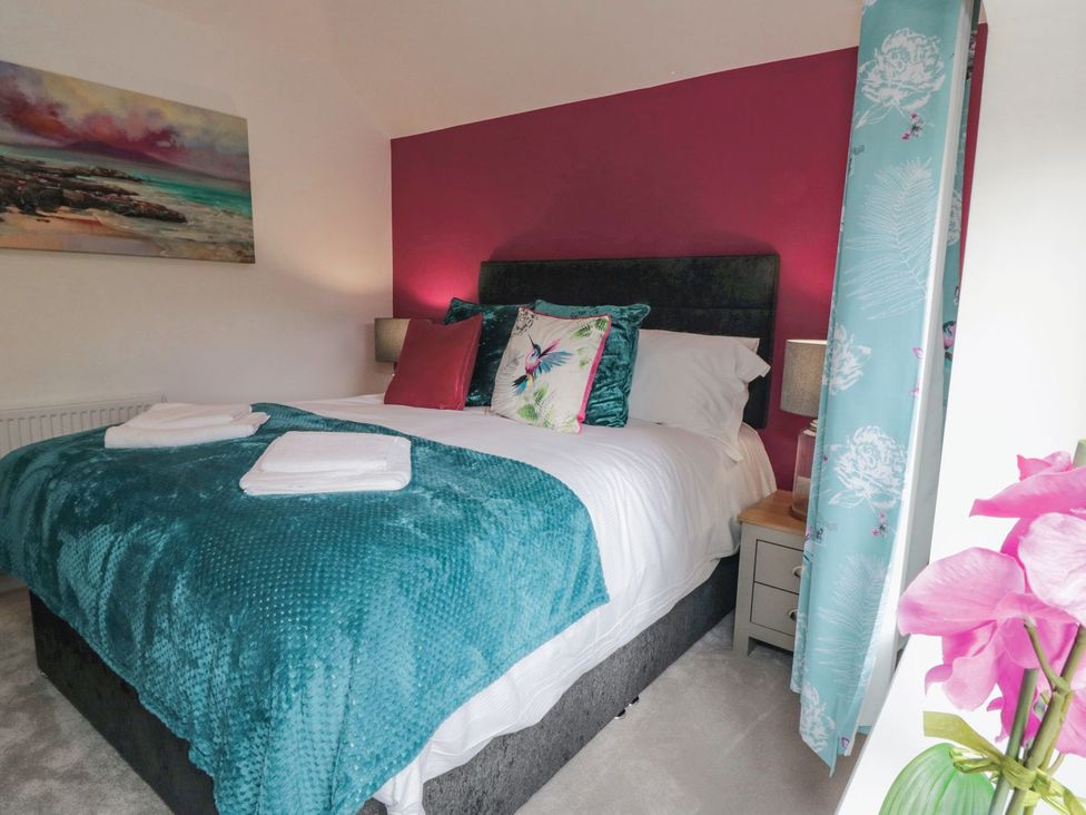 A bedroom with a bed and bedside table at Riverside House in Scarborough