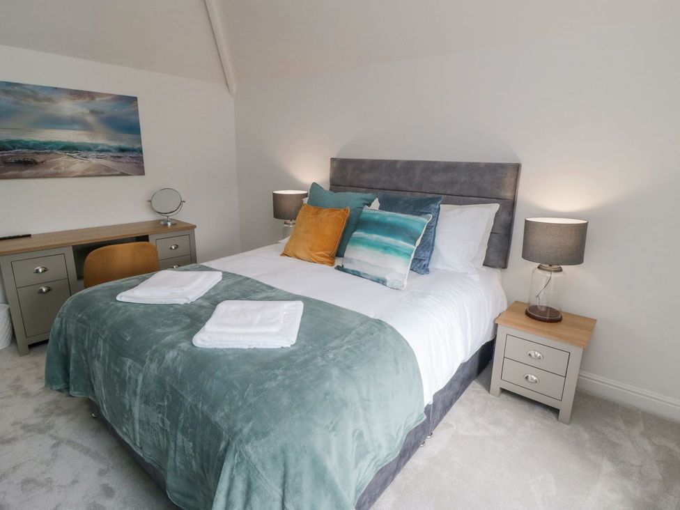 A bedroom with a bed and a desk at Riverside House in Scarborough