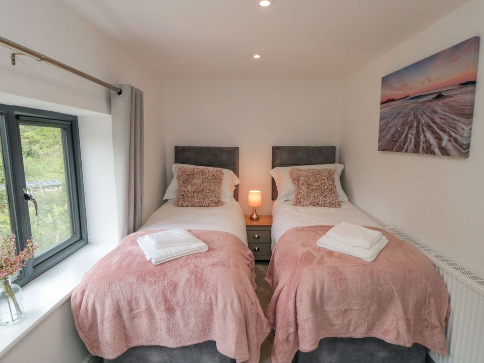 A bedroom with two beds and a window at Riverside House in Scarborough