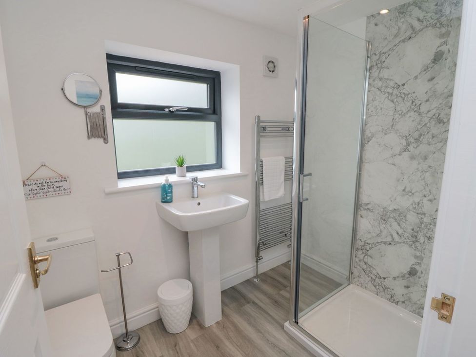 A bathroom with a shower and sink at Riverside House in Scarborough