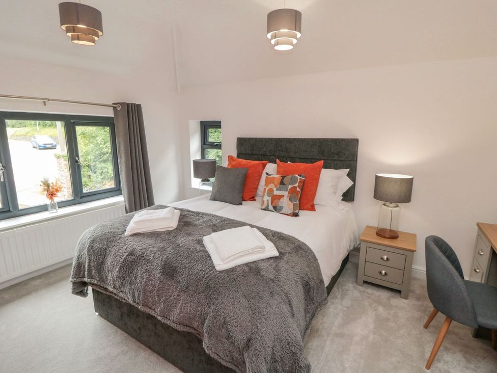 A bedroom with a bed and a nightstand at Riverside House in Scarborough