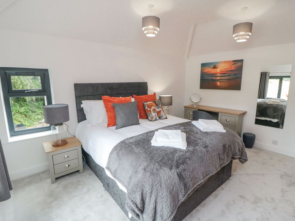 A bedroom with a bed and lamp at Riverside House in Scarborough