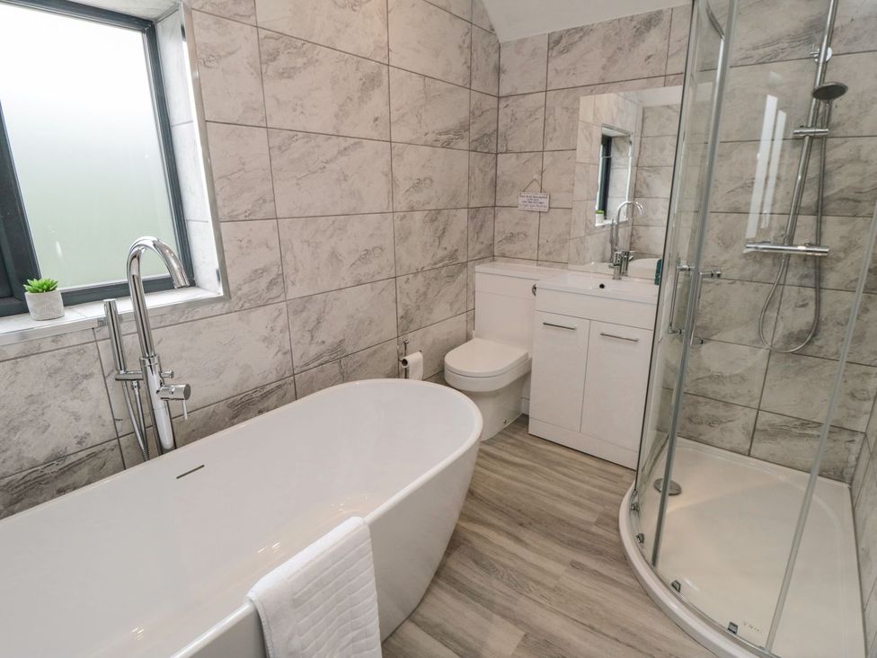 A bathroom with a bathtub and shower at Riverside House in Scarborough