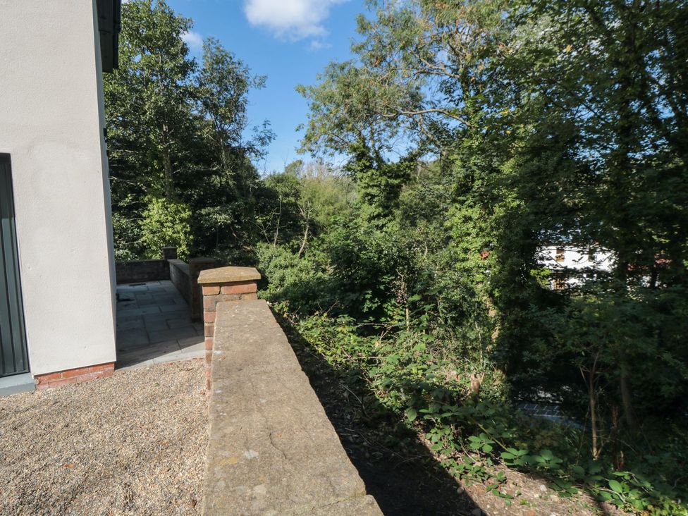 An outdoor area with a wall and trees at Riverside House in Scarborough