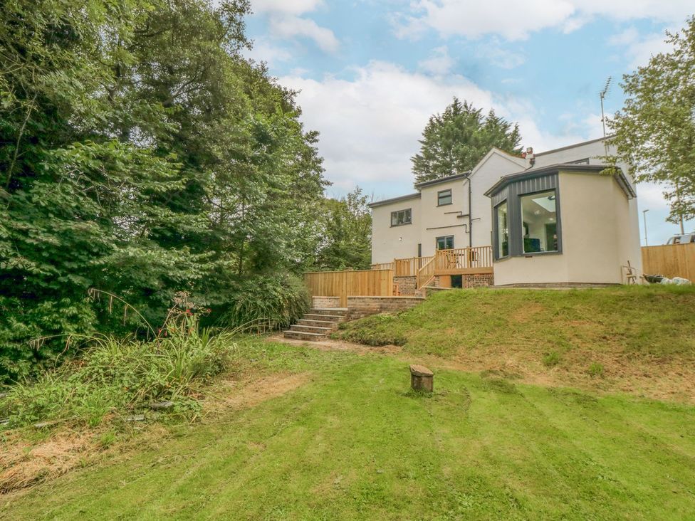 A garden with a house and decking area at Riverside House Scarborough