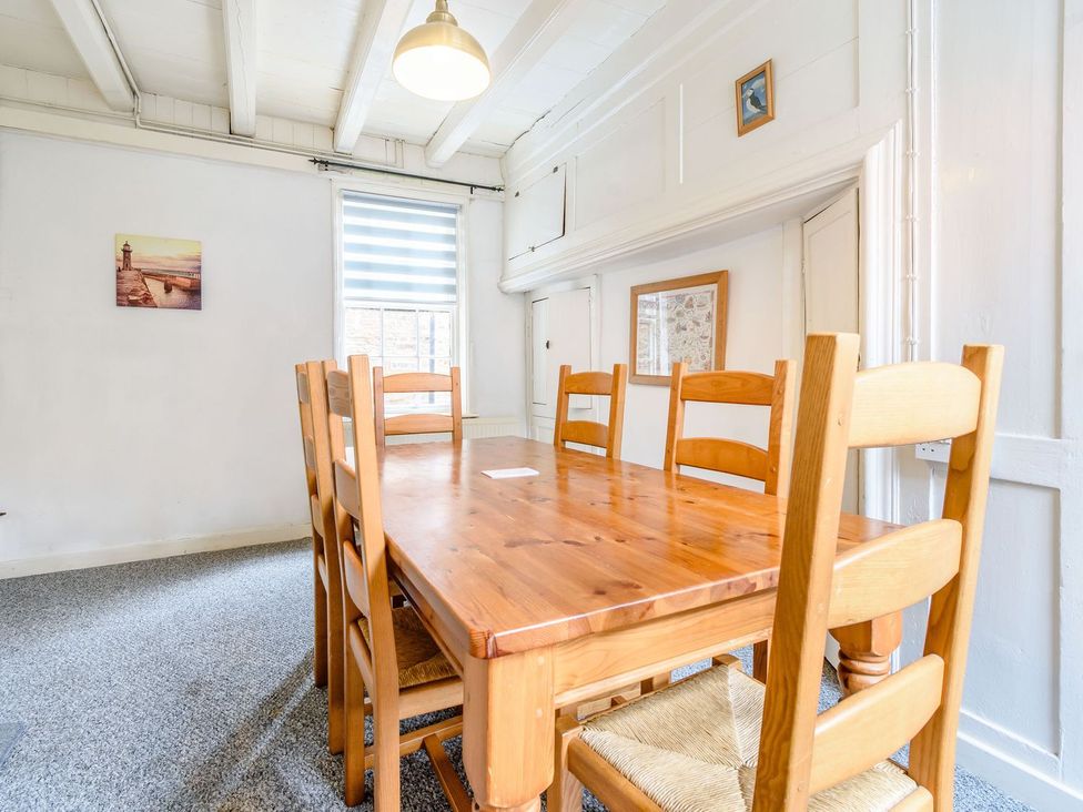 A dining room with a wooden table and chairs at The Anchorage in Whitby