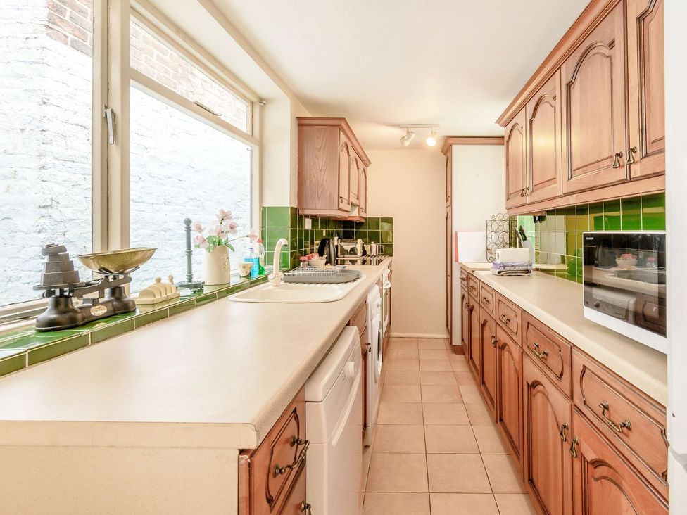 A kitchen with cabinets and appliances at The Anchorage in Whitby