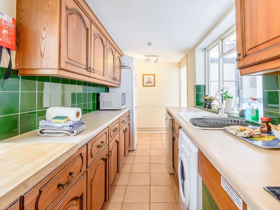 A kitchen with cabinets, a sink, and appliances at The Anchorage in Whitby