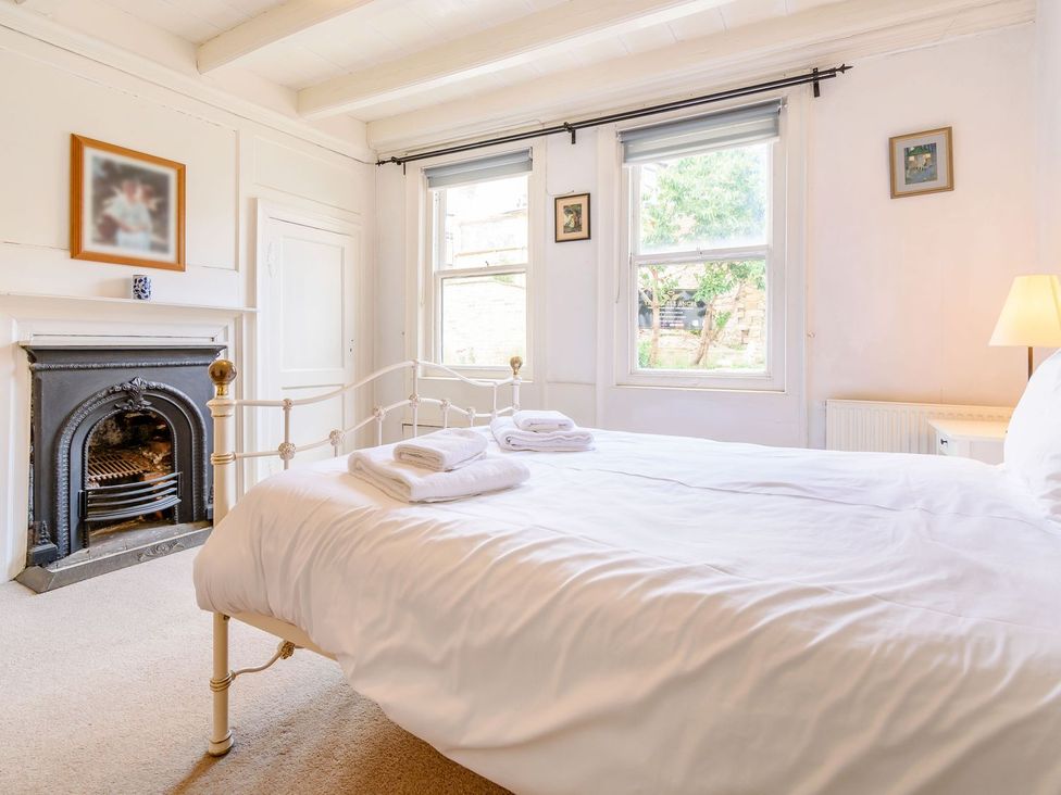 A bedroom with a bed and a fireplace at The Anchorage in Whitby