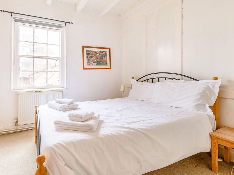 A bedroom with a bed and window at The Anchorage in Whitby