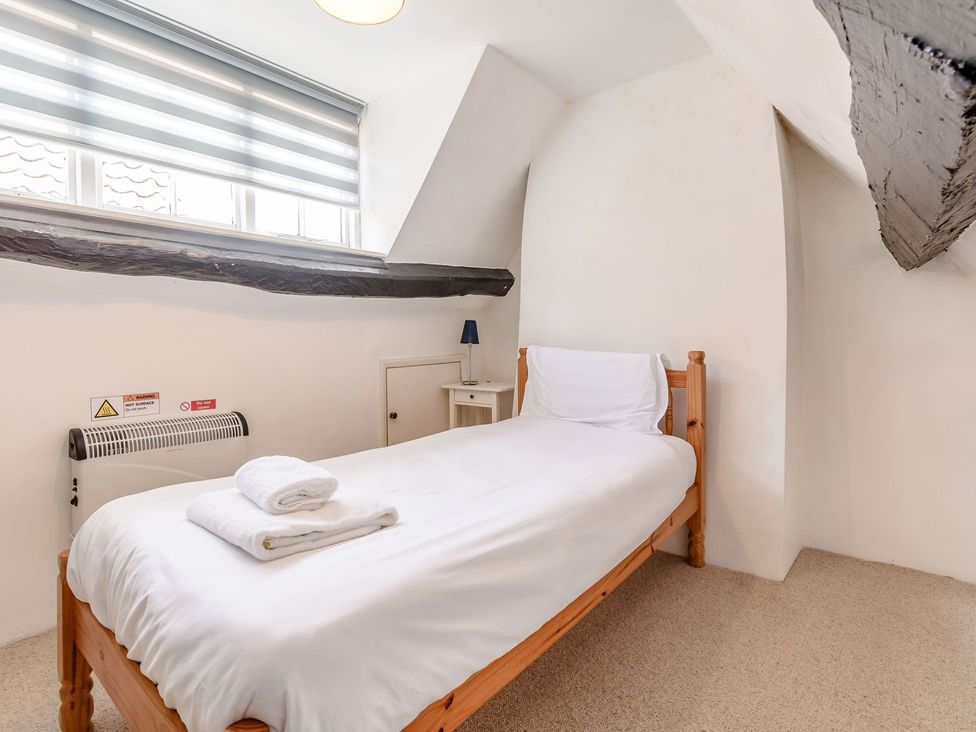A bedroom with a single bed and a nightstand at The Anchorage in Whitby