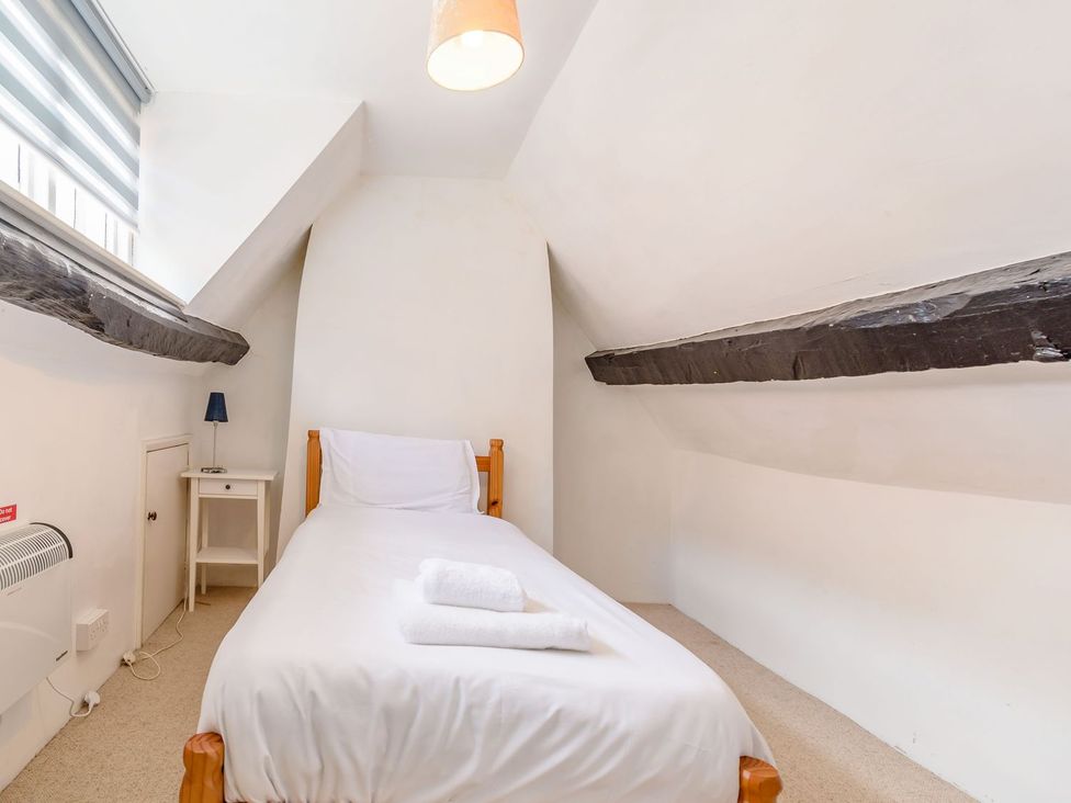 A bedroom with a single bed and a lamp at The Anchorage in Whitby