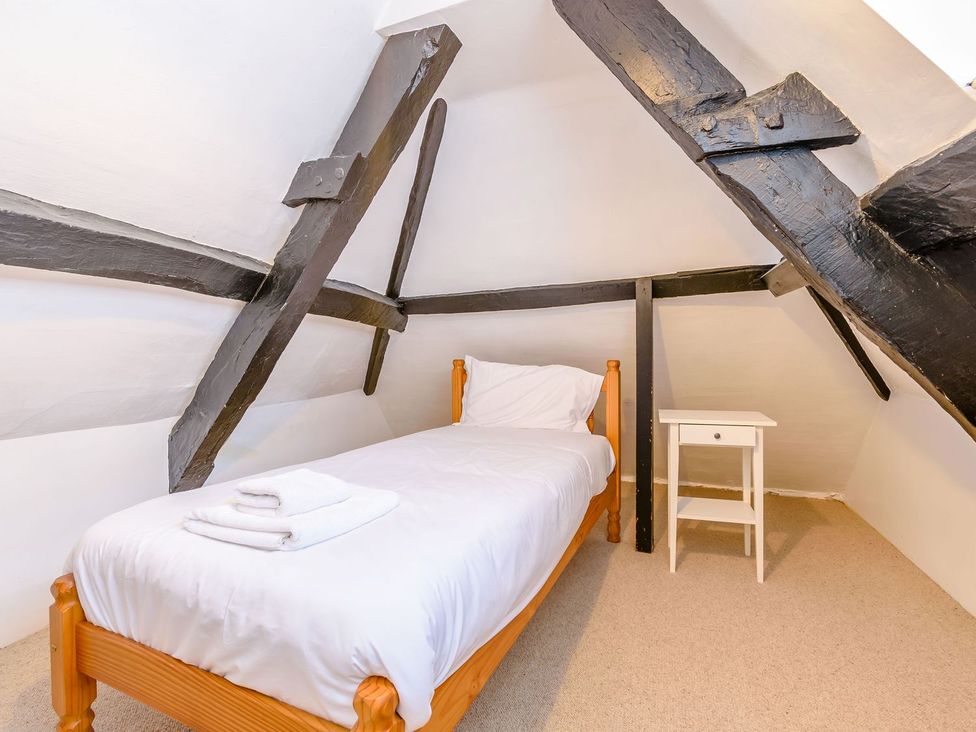 A bedroom with a bed and nightstand at The Anchorage in Whitby