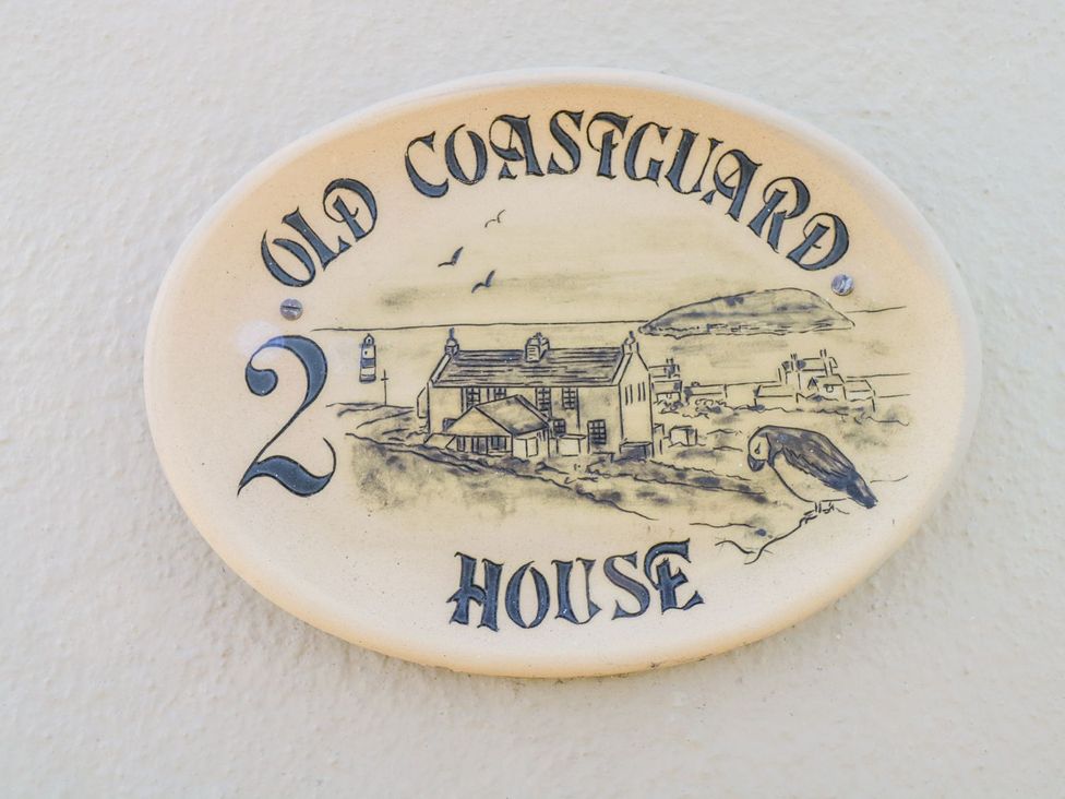 A house nameplate with illustration at 2 Old Coastguard House in Beaumaris