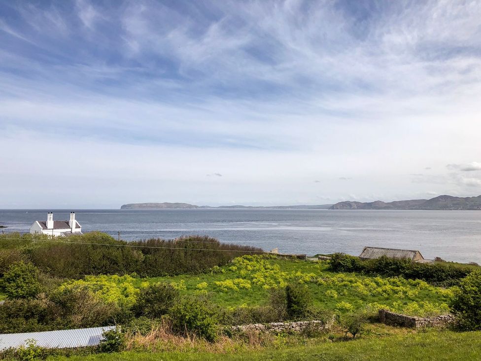 A coastal view with a house near the sea at 2 Old Coastguard House Beaumaris