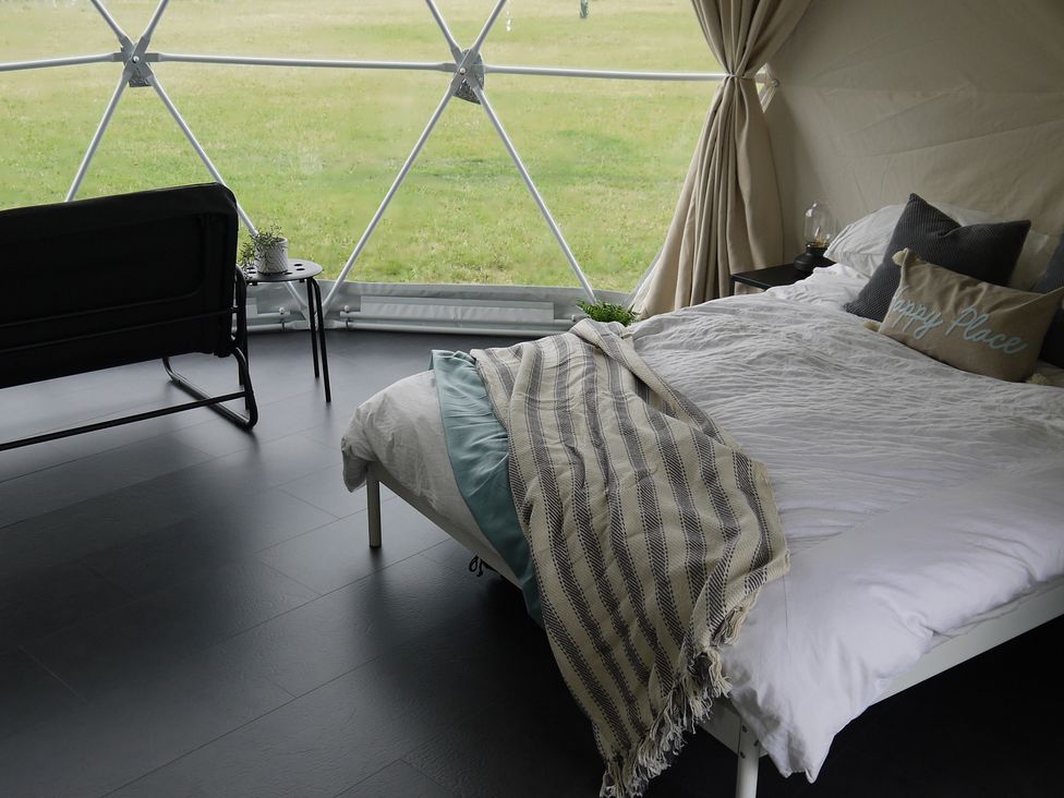 A bedroom with a bed and a sofa at Sherwood - Geodome in Mansfield
