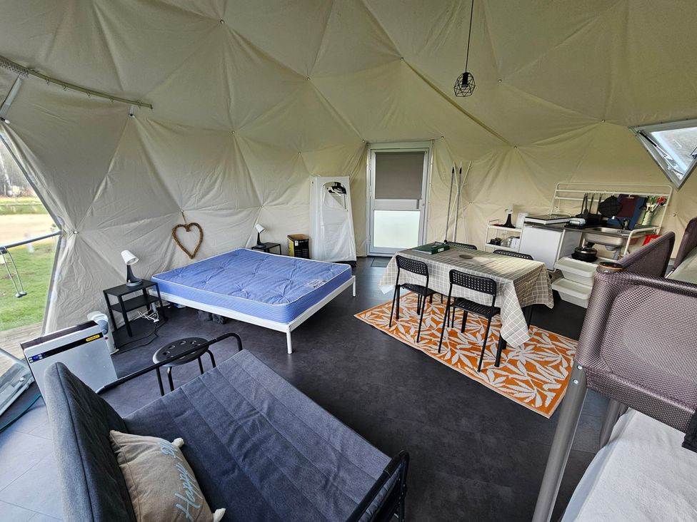 A living area with a bed, dining table, and kitchenette at Sherwood - Geodome in Mansfield