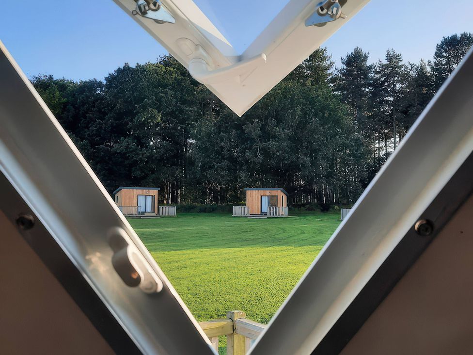 A view from a window showing huts and trees at Sherwood - Geodome in Mansfield
